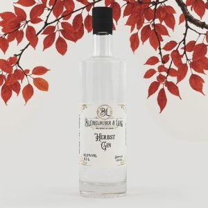Produktabbildung Blümelhuber & Lang Herbst Gin - Flasche vor grauem Hintergrund und Ästen mit rotem Herbstlaub daran